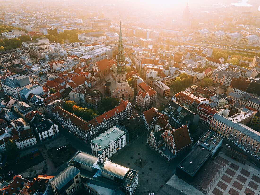 Aerial drone sunrise view of St. Peter's Church and House of the Black Heads, Riga Old Town (Vecriga), UNESCO World Heritage Site, Riga, Latvia, Europe