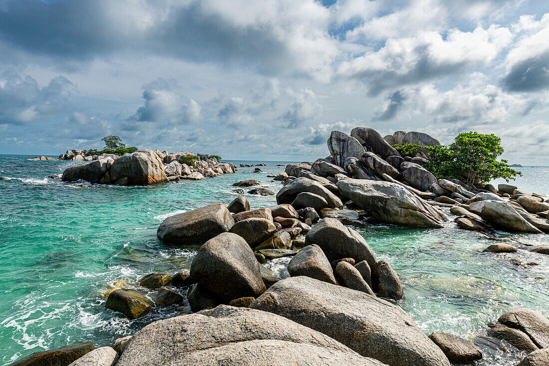 Granite rocks sticking out of the ocean, Belitung island off the coast of Sumatra, Indonesia, Southeast Asia, Asia