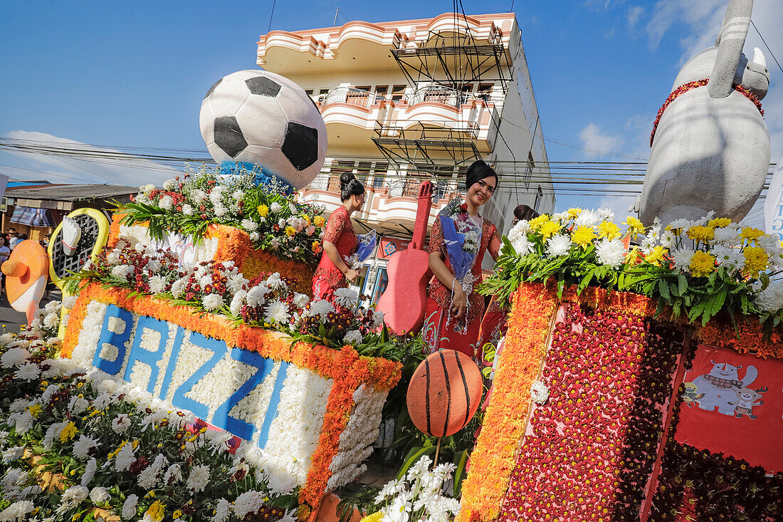 Women on a bank's large float at the annual Tomohon International Flower Festival parade, Tomohon, North Sulawesi, Sulawesi, Indonesia, Southeast Asia, Asia