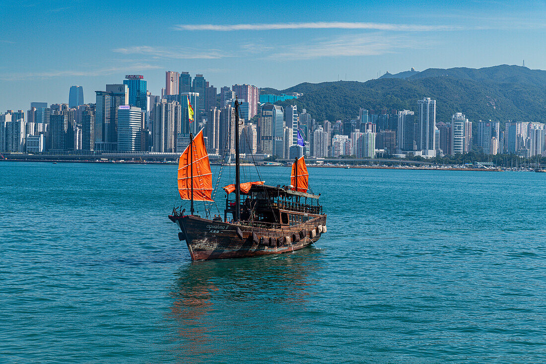 Traditional sailing boat in front of high rise buildings in Central Hongkong, China, Asia