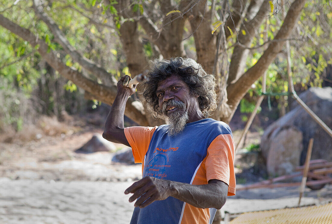 Portrait, Yolngu man, showing spear fishing action at Bawaka Homeland, East Arnhem Land, Northern Territory, Australia, Pacific