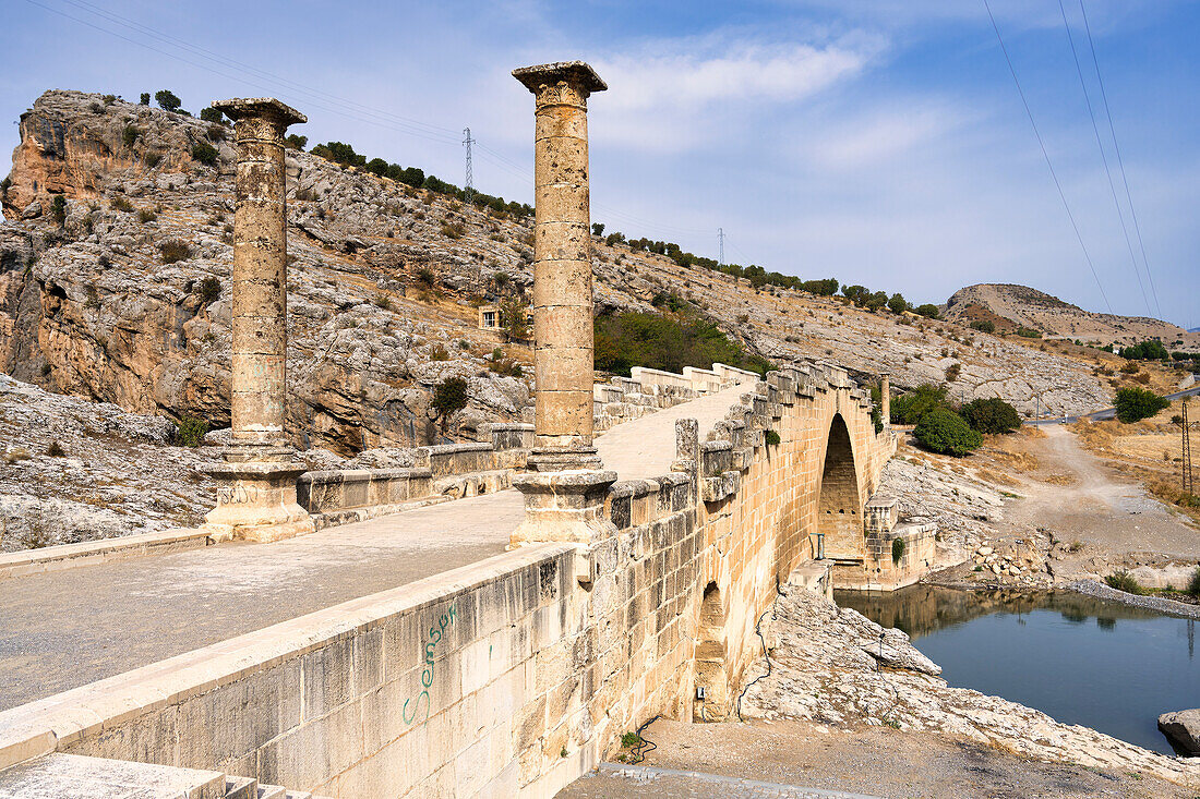 The 2nd century AD Severan Roman Bridge on the Cendere River with the columns of the Roman Emperor Septimus Severus and Empress Julia Domna, Turkey, Asia Minor, Asia