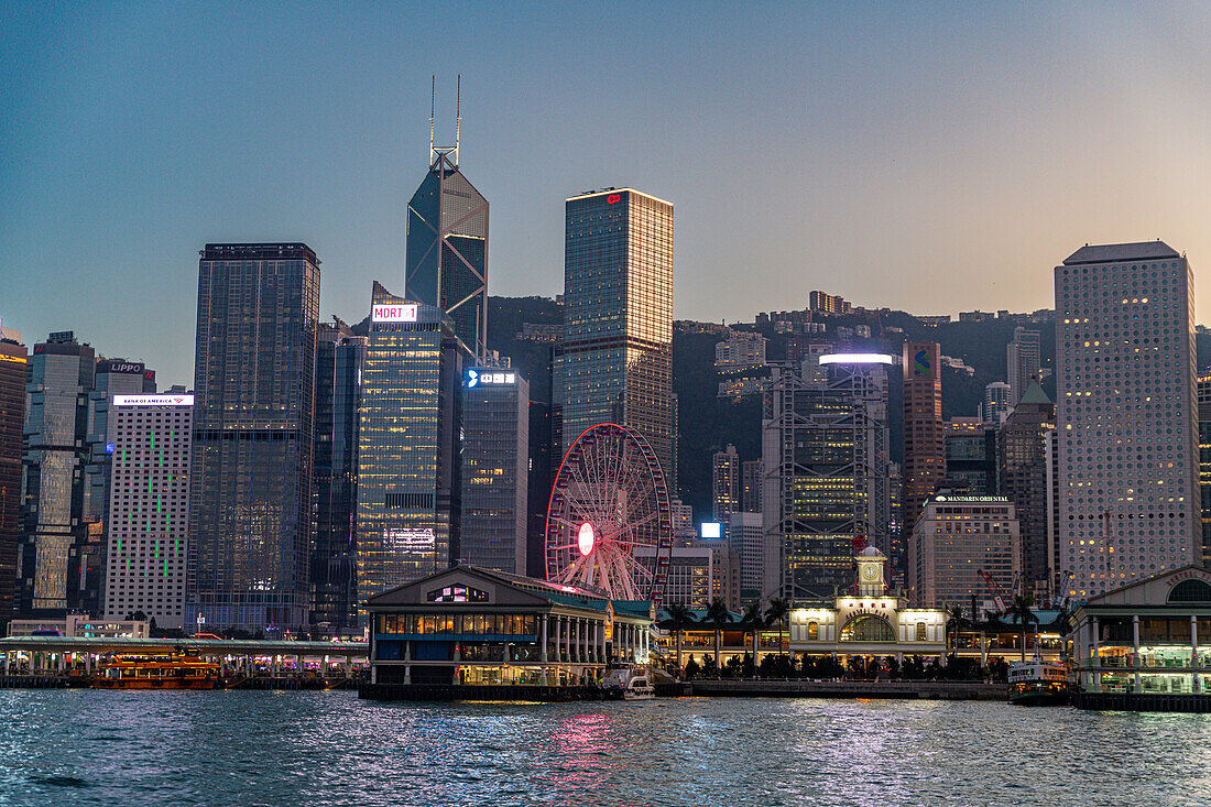 Highrise buildings in Victoria harbour at sunset, Hong Kong, China, Asia