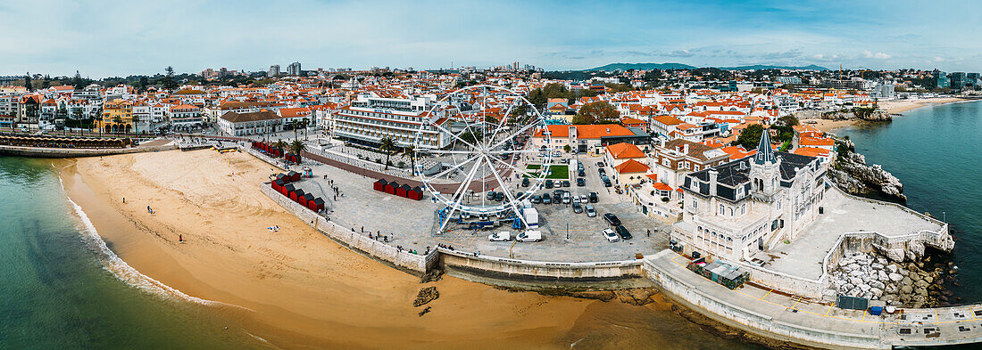 Aerial drone panoramic view of Ribeira beach with a ferris wheel set up during the winter months, Cascais, Portugal, Europe