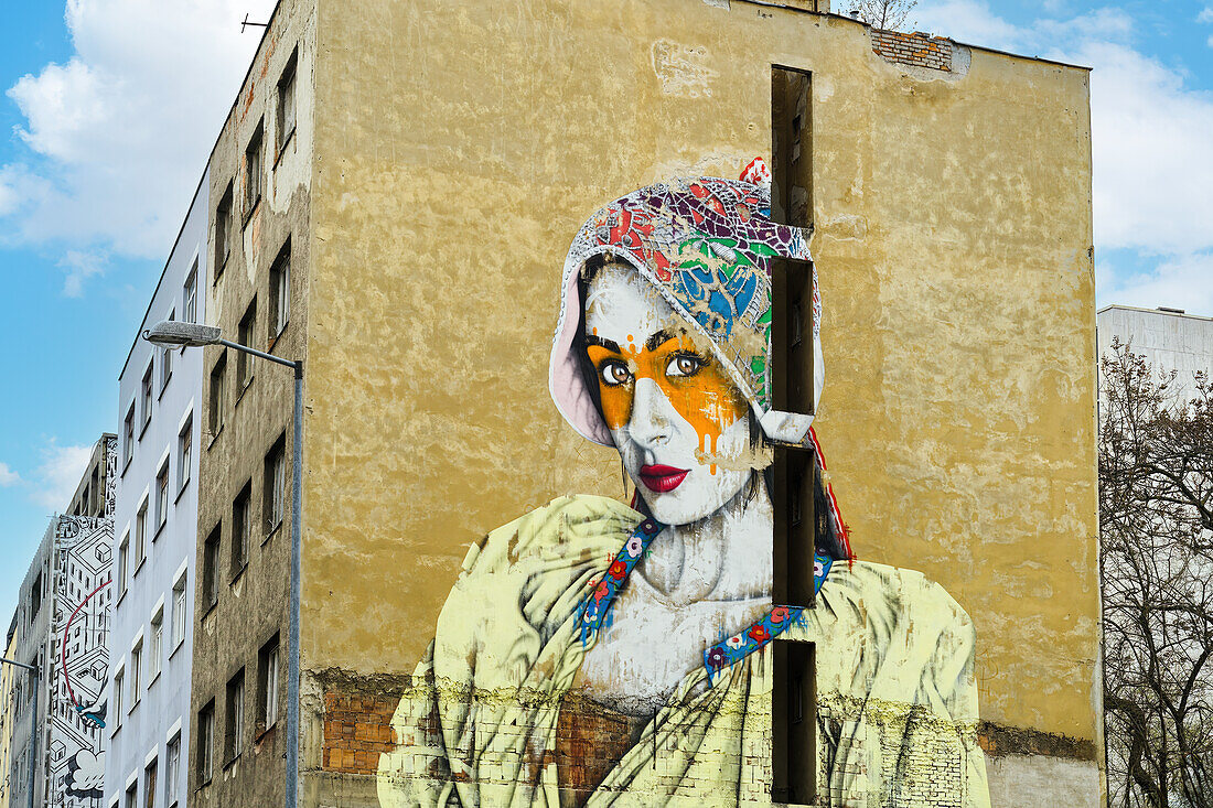 Vivid graffiti depicting a young adult female on side wall of a building, Bratislava, Slovakia, Europe