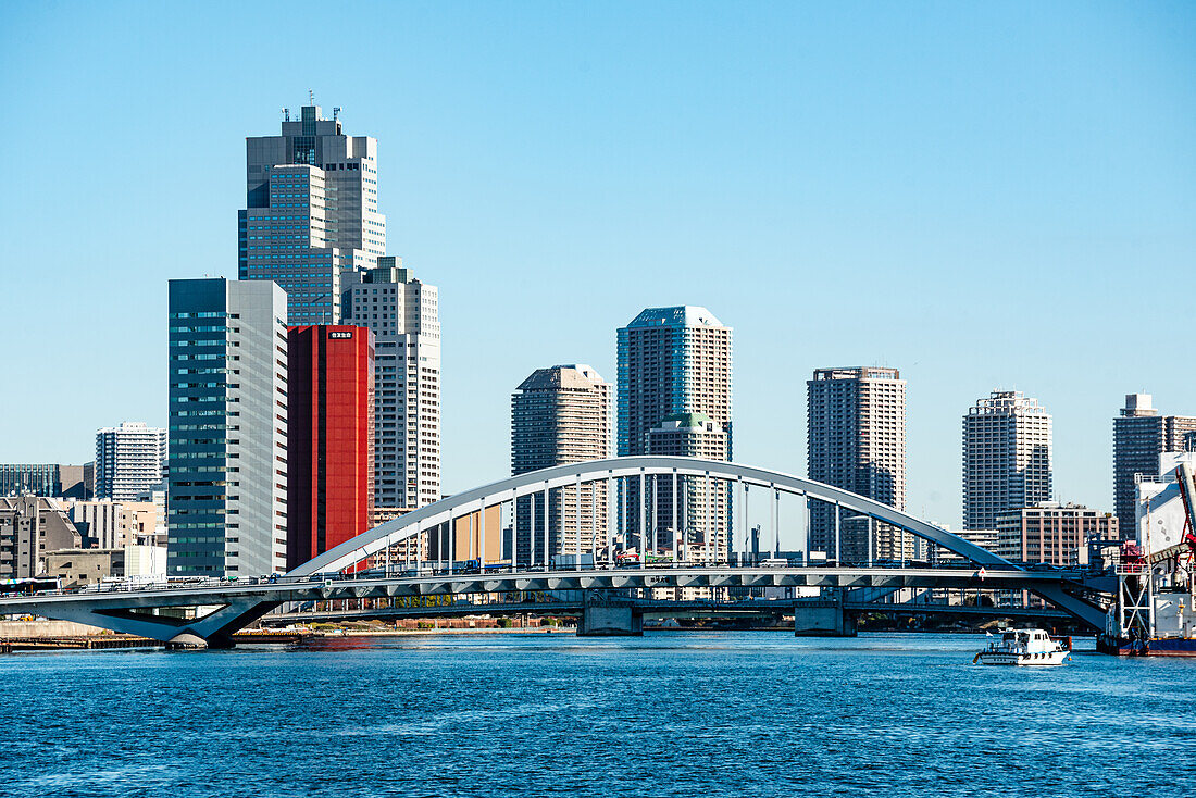 Arched bridges over the Sumida river and blue sky day with skyscrapers of Kiba in the background, Tokyo, Honshu, Japan, Asia