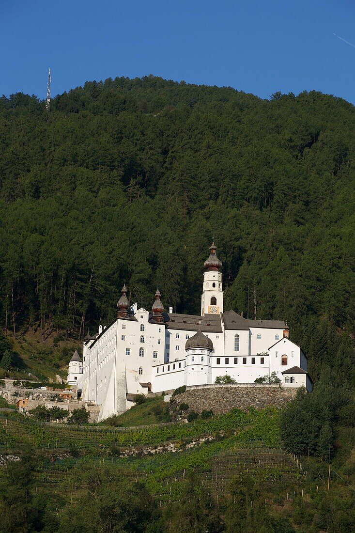 Italy, autonomous province of Bolzano, Val Pusteria, Marienberg abbey perched on the side of a green mountain