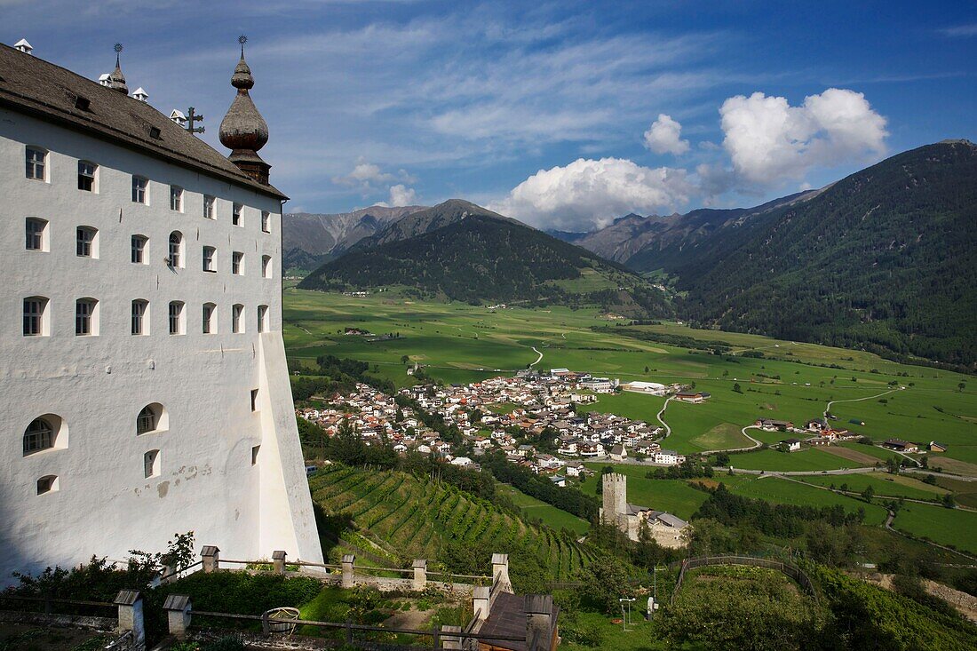 Italy, autonomous province of Bolzano, Val Venosta, Marienberg abbey perched on the side of a mountain and overlooking a green valley and the village of Burgusio