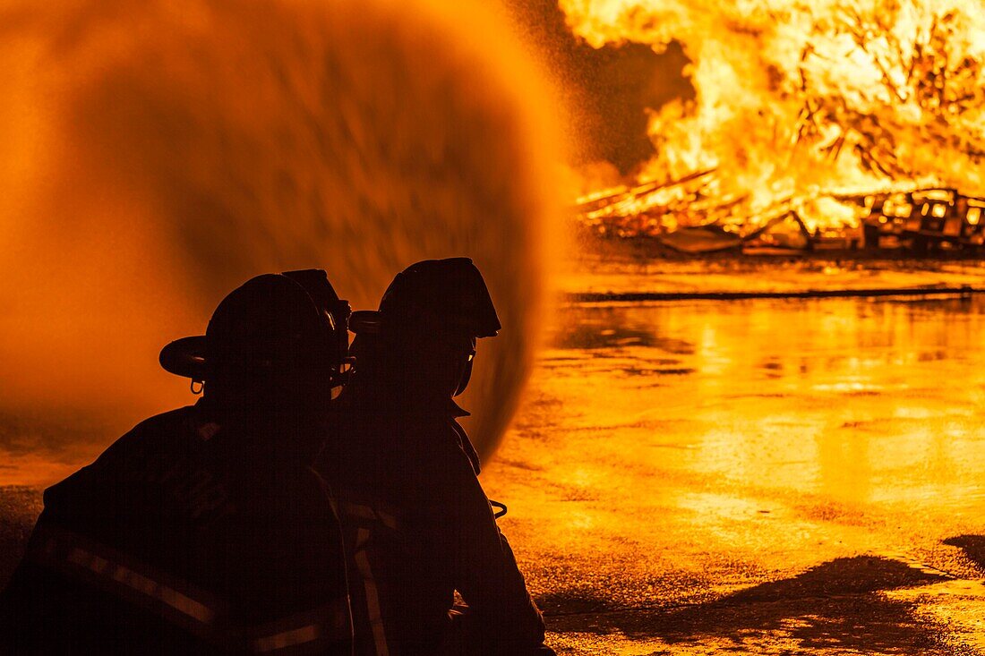 United States, New England, Massachusetts, Cape Ann, Rockport, Rockport Fourth of July Parade, Firemen silhouettes by holiday bonfire