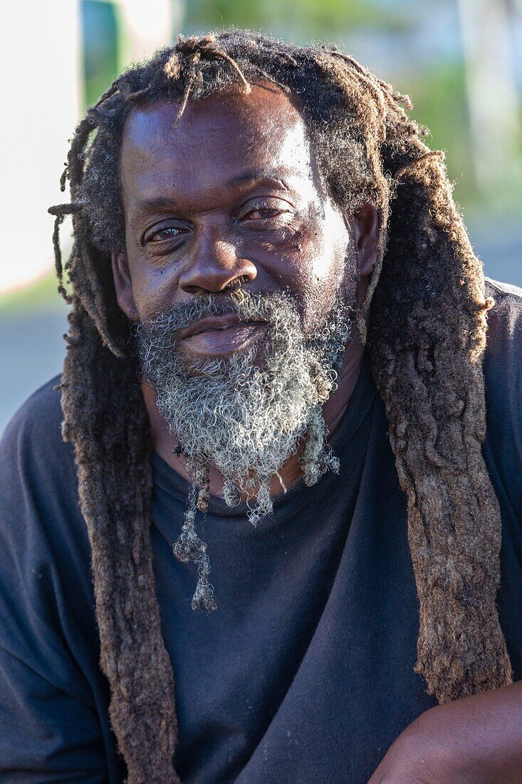 West Indies, British Virgin Islands, Tortola Island, on the beach of Carrot Bay a dreadlok fisherman takes the pose