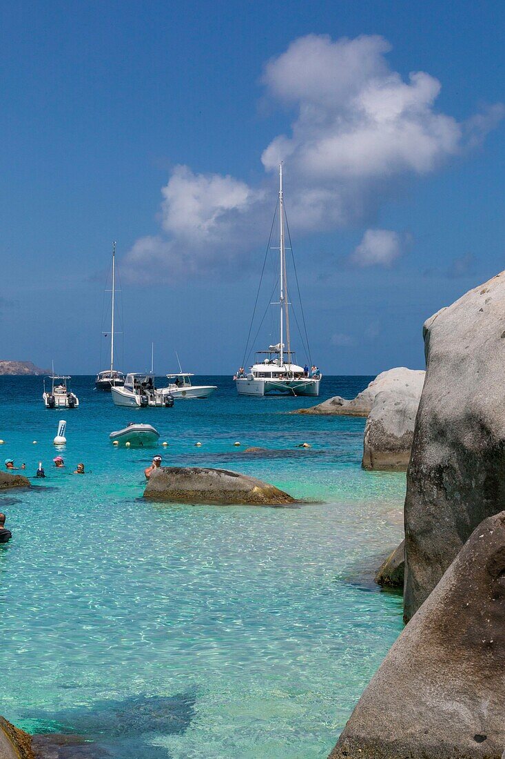 West Indies, British Virgin Islands, Virgin Gorda Island, The Baths, view of the bathing beach, sailboats and motor boats at anchor, in the foreground the typical rocks that surround the paradisiacal swimming area