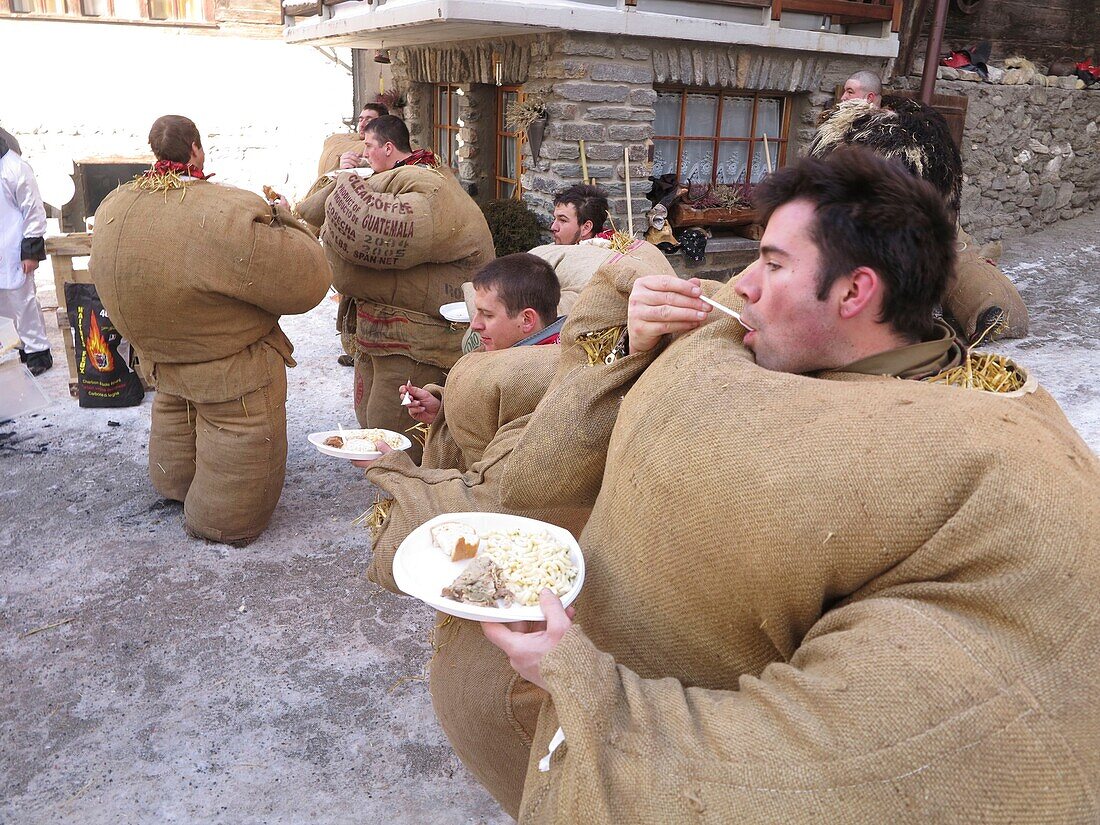 Schweiz, Kanton Wallis, Val d'Herens, Evolene, Fasnacht, Tradition der verkleideten Männer mit Säcken, die mit 30 Kilogramm Stroh gefüllt sind