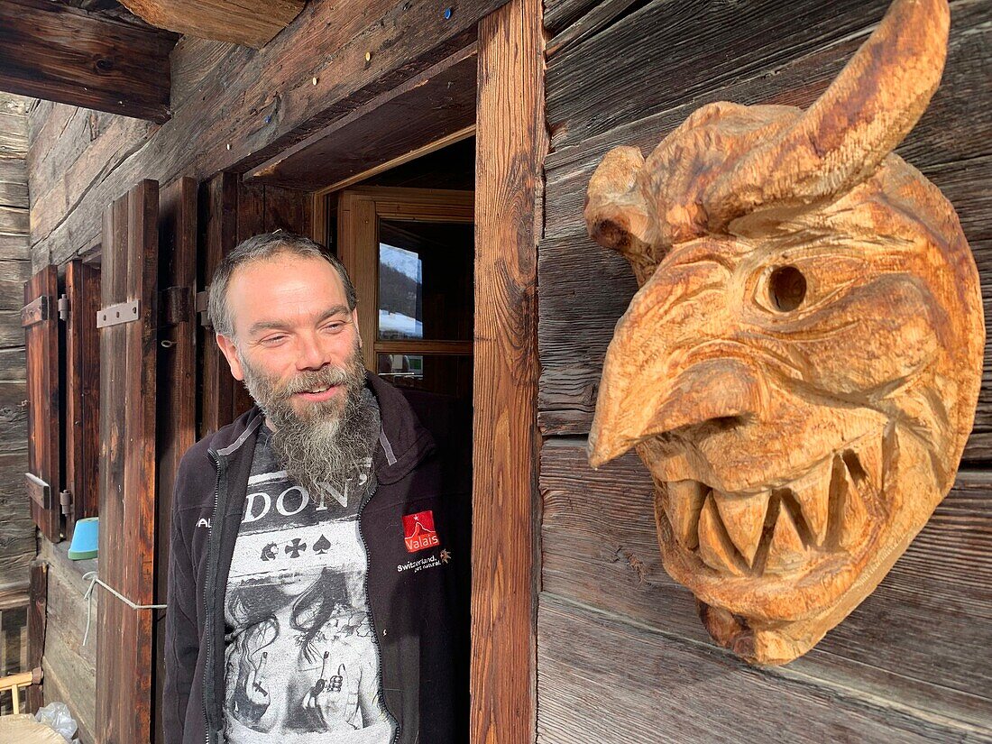 Switzerland, Valais Canton, Val d'Herens, Evolene county in winter, Mr Beytrison sculpror of traditional carnaval masks