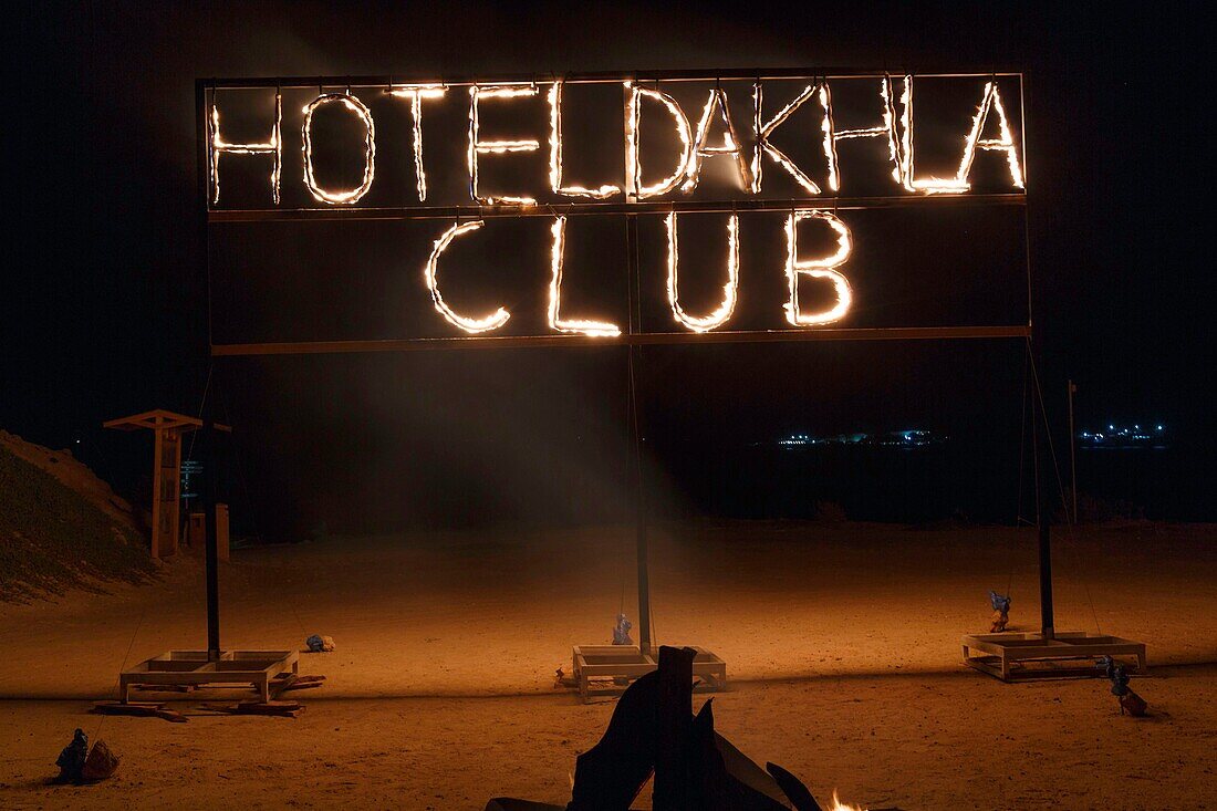 Marocco, Oued Ed-Dahab, Dakhla,Dakhla Club Resort, flaming letters on a portico on the beach in the middle of the night