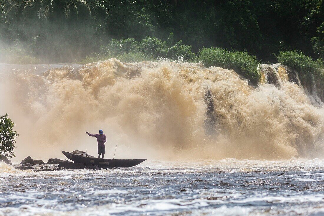 Cameroon, South Region, Ocean Department, Kribi, fisherman in a canoe in front of Lobe Waterfall