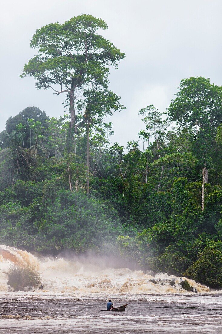 Cameroon, South Region, Ocean Department, Kribi, fisherman in a canoe in front of Lobe Waterfall