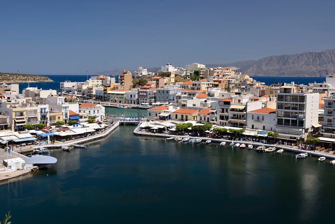 Greece, Crete, Agios Nikolaos, Lake Voulismeni, basin connected to the sea lined with cafes and taverns