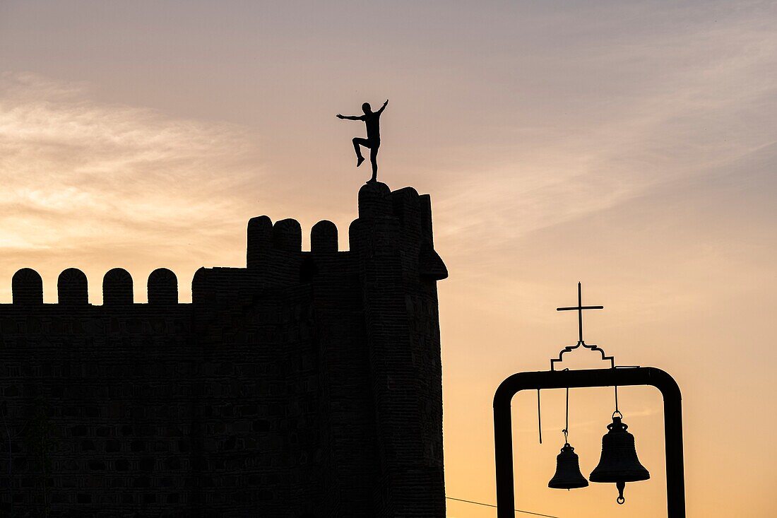 Georgia, Tbilisi, tourist doing acrobatics on Narikala fortress which overlooks the Old Tbilisi (or Dzveli Kalaki)