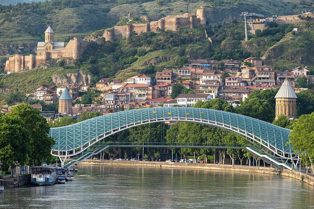 Georgia, Tbilisi, Bridge of Peace and Old Tbilisi (or Dzveli Kalaki) dominated by Narikala fortress