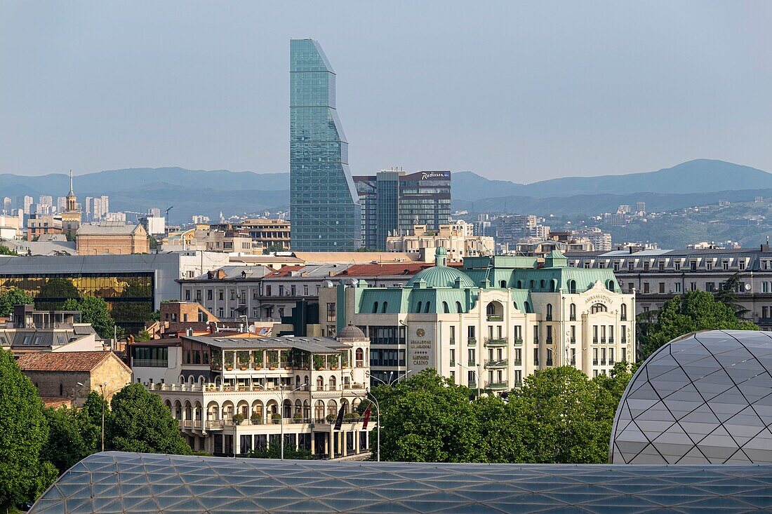 Georgia, Tbilisi, panorama over the new town, the glass tower of The Biltmore Hotel Tbilisi in the background