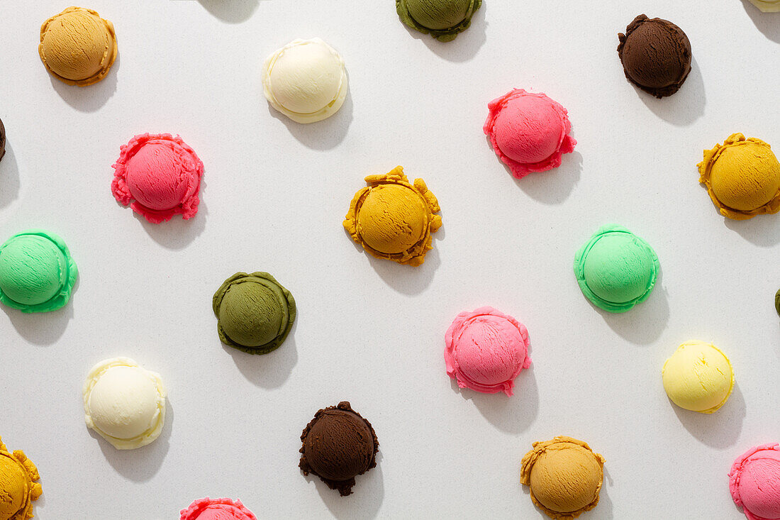 Assorted colorful ice cream scoops on a white background