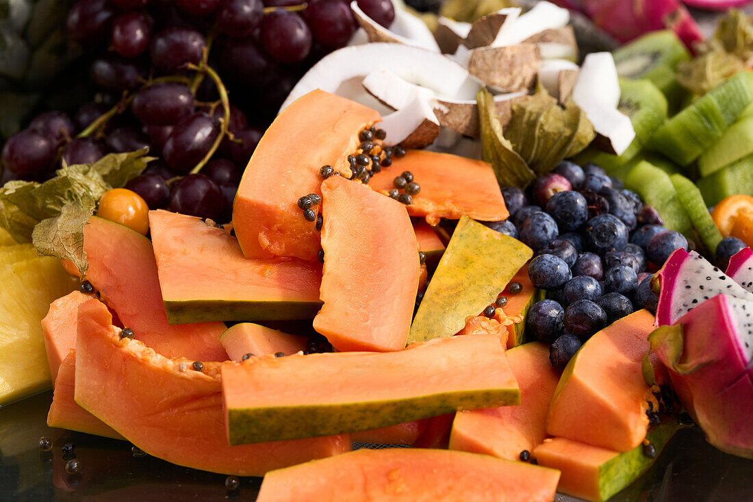 assorted exotic fruits pumpkin kiwifruit grapes coconut raspberries