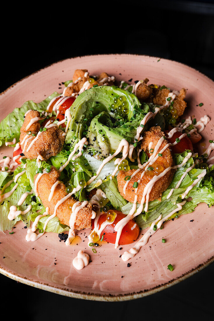 Exquisite house salad with a mezclum base, cherry tomatoes, avocado, topped with tempura prawns and a drizzle of truffle mayonnaise.