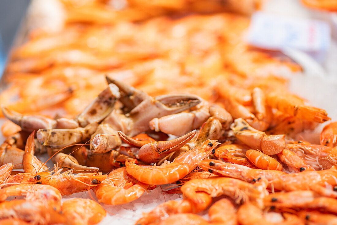 Fresh seafood display with prawns and a crab at a market stall