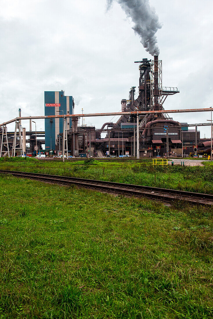 Huge, heavy steel production plant and industry terrain, producing various kinds of steel inside an CO2 Emitting and Exhausting Factory. IJmuiden, Netherlands.