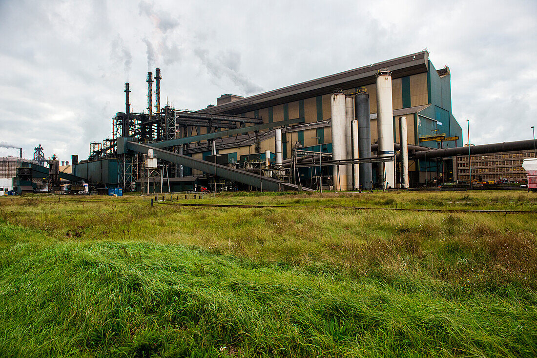 Huge, heavy steel production plant and industry terrain, producing various kinds of steel inside an CO2 Emitting and Exhausting Factory. IJmuiden, Netherlands.