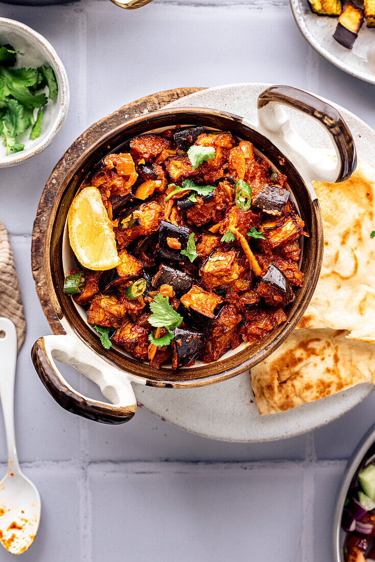 An aubergine bhaji, traditional Indian cuisine served with accompaniments