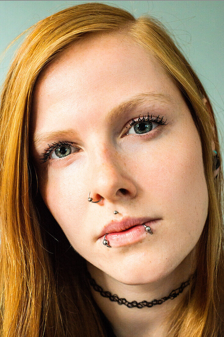 Tilburg, Netherlands. Close up portrait of a young, red haired woman. Enhanced.