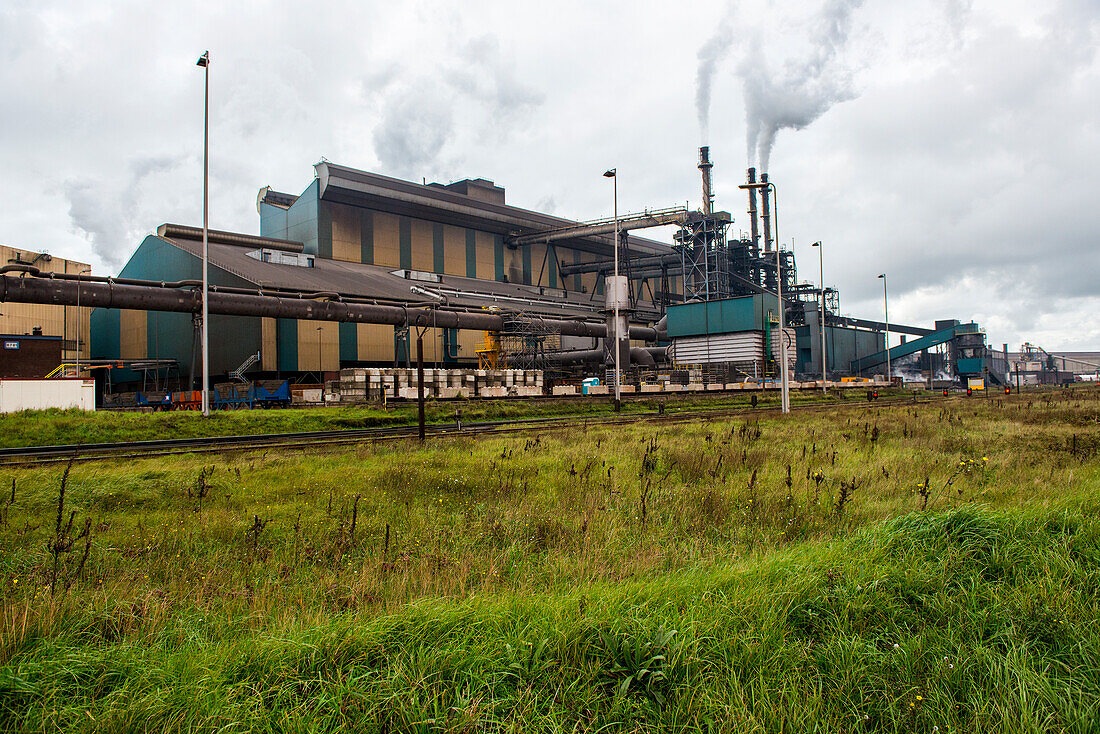 Huge, heavy steel production plant and industry terrain, producing various kinds of steel inside an CO2 Emitting and Exhausting Factory. IJmuiden, Netherlands.