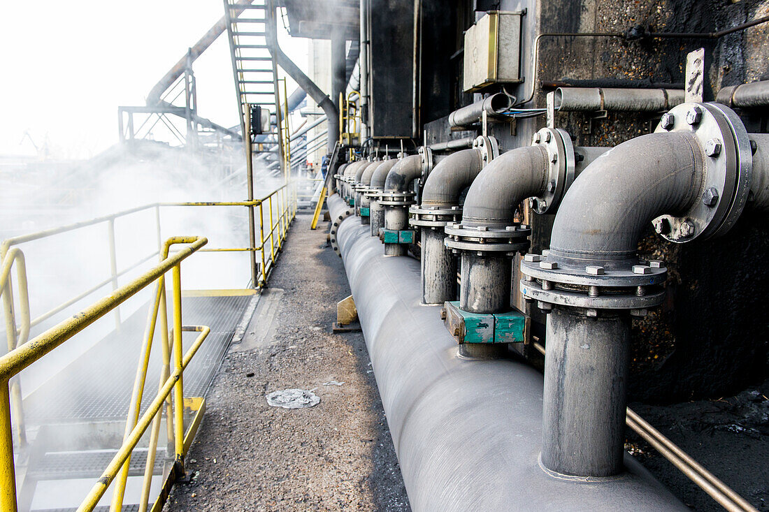 Huge, heavy steel production plant and industry terrain, producing various kinds of steel inside an CO2 Emitting and Exhausting Factory. IJmuiden, Netherlands.