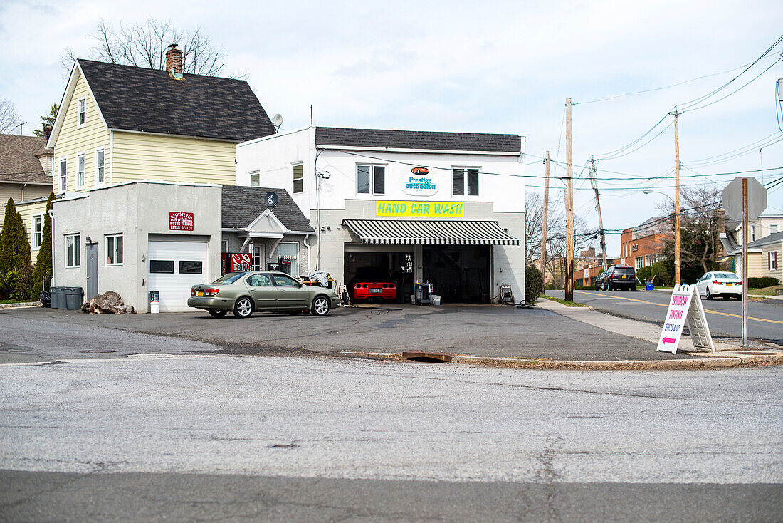 Harrison, New York, USA. Small and cosy car wash with square in front.