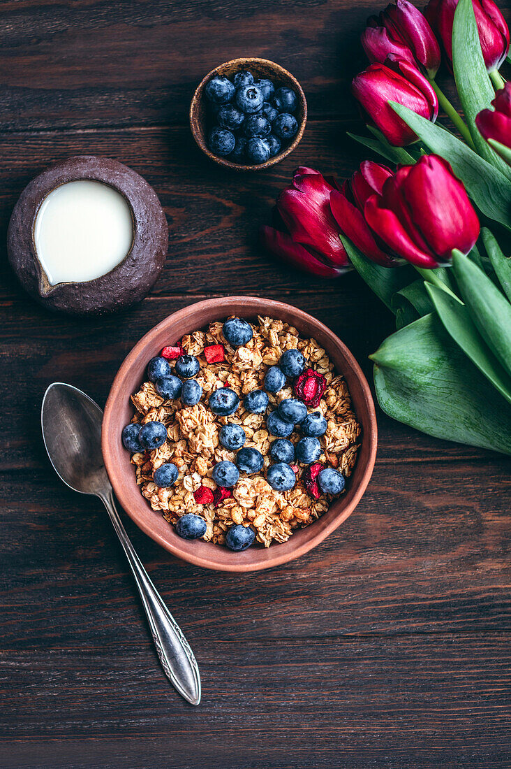 Muesli with cherries and blueberries in a ceramic bowl