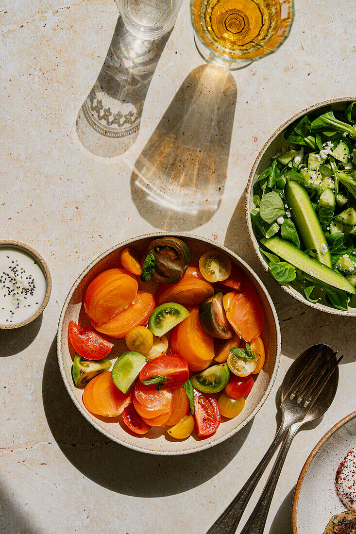 Flat lay of salads in harsh light on a stone background