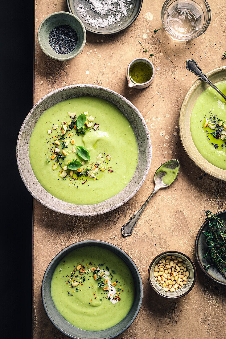 Green soup with herbs on a brown background