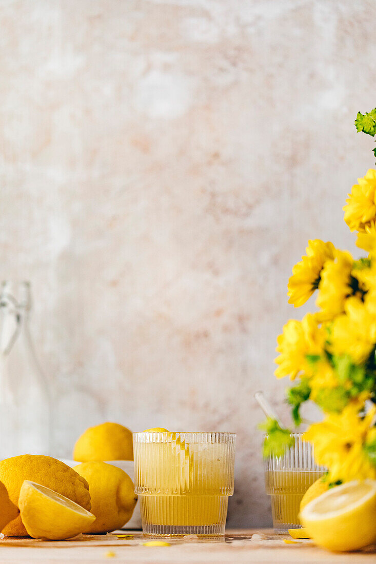 Fresh homemade lemonade, with lemons and flowers. With copy space.