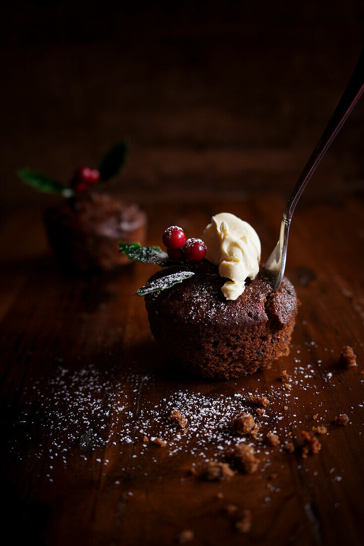 Mini Christmas plum pudding with dollop of cream, with copy space.