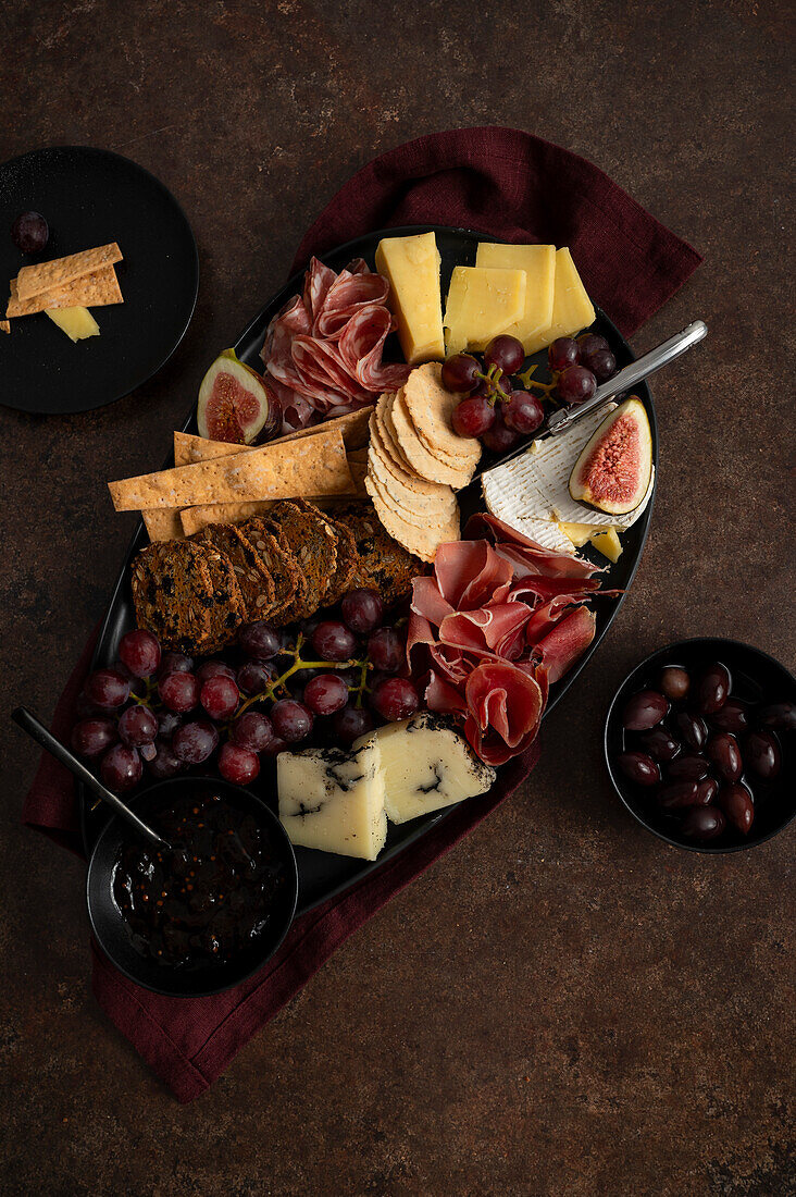 Rich cheese platter on a brown background