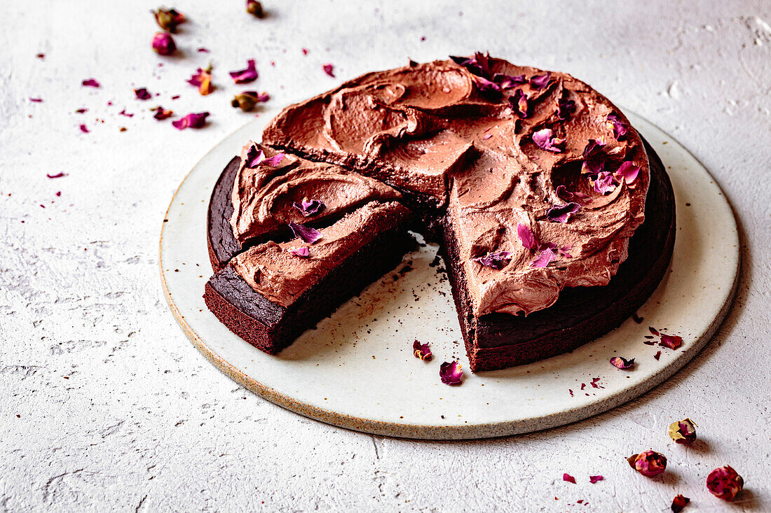 Chocolate cake with chocolate frosting and dried rose petals