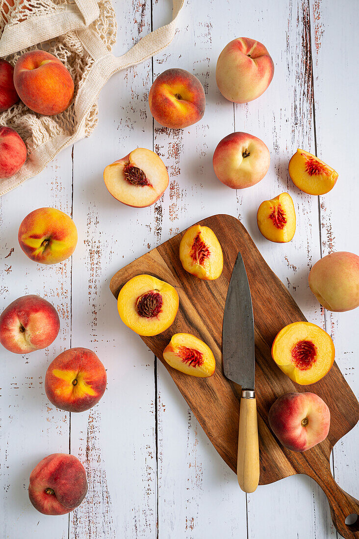 Sliced peaches on a whitewashed table