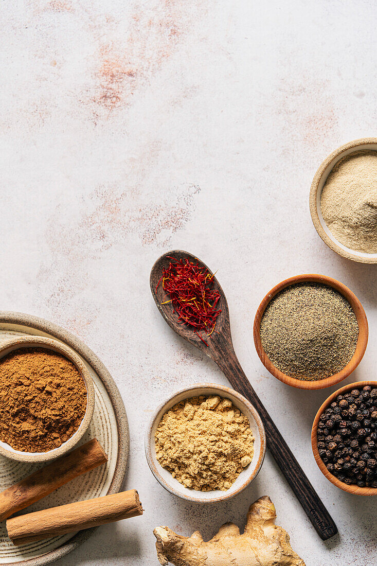 Ground spices in bowls on a neutral background