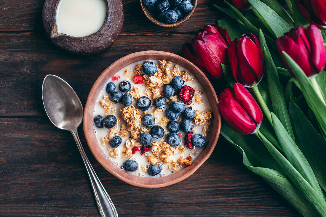 Muesli with cherries and blueberries in a ceramic bowl