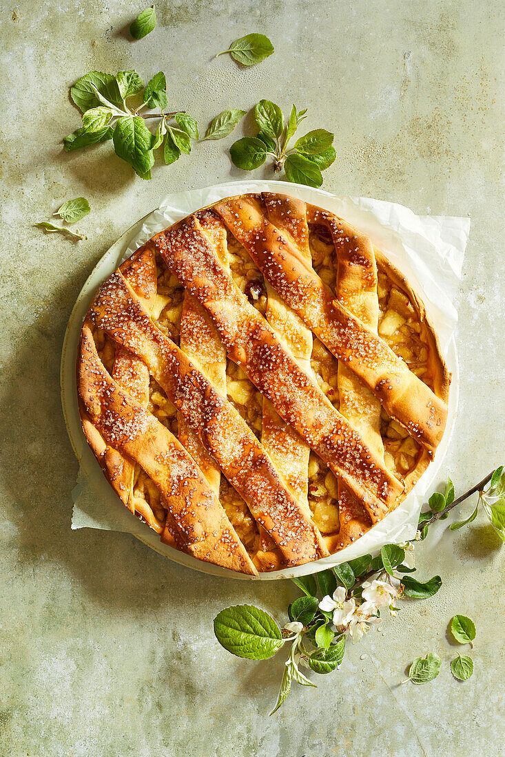 homemade apple pie on a light green stone backround