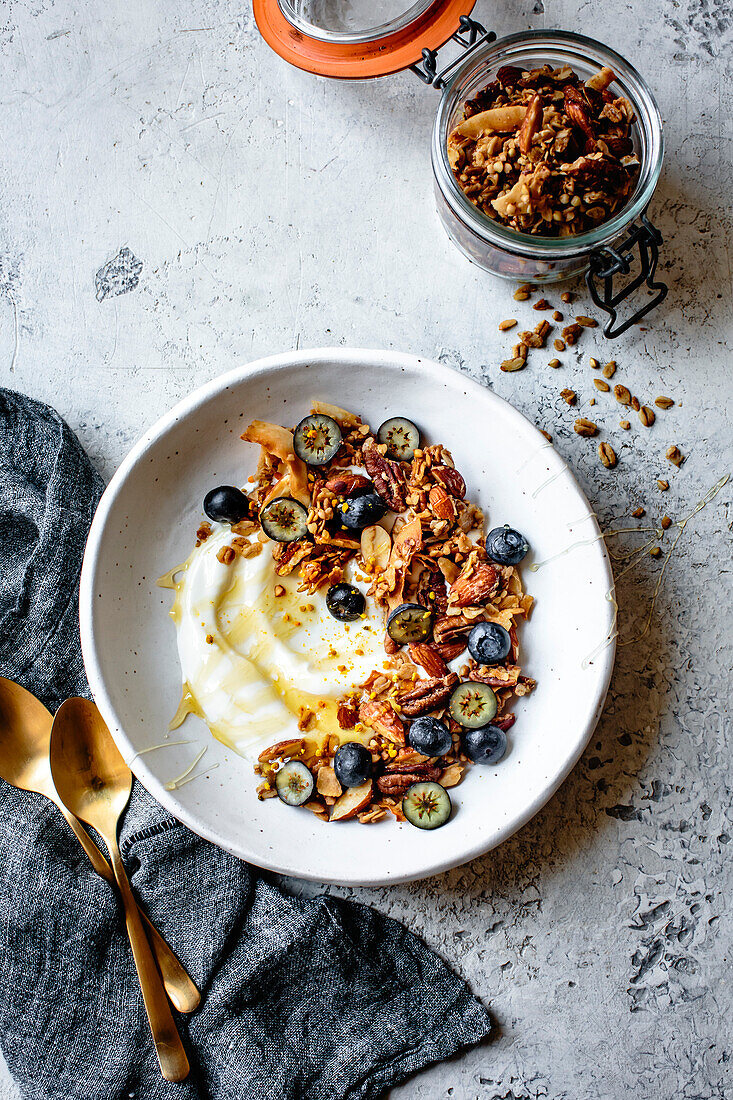 Yoghurt granola bowl with honey and blueberries