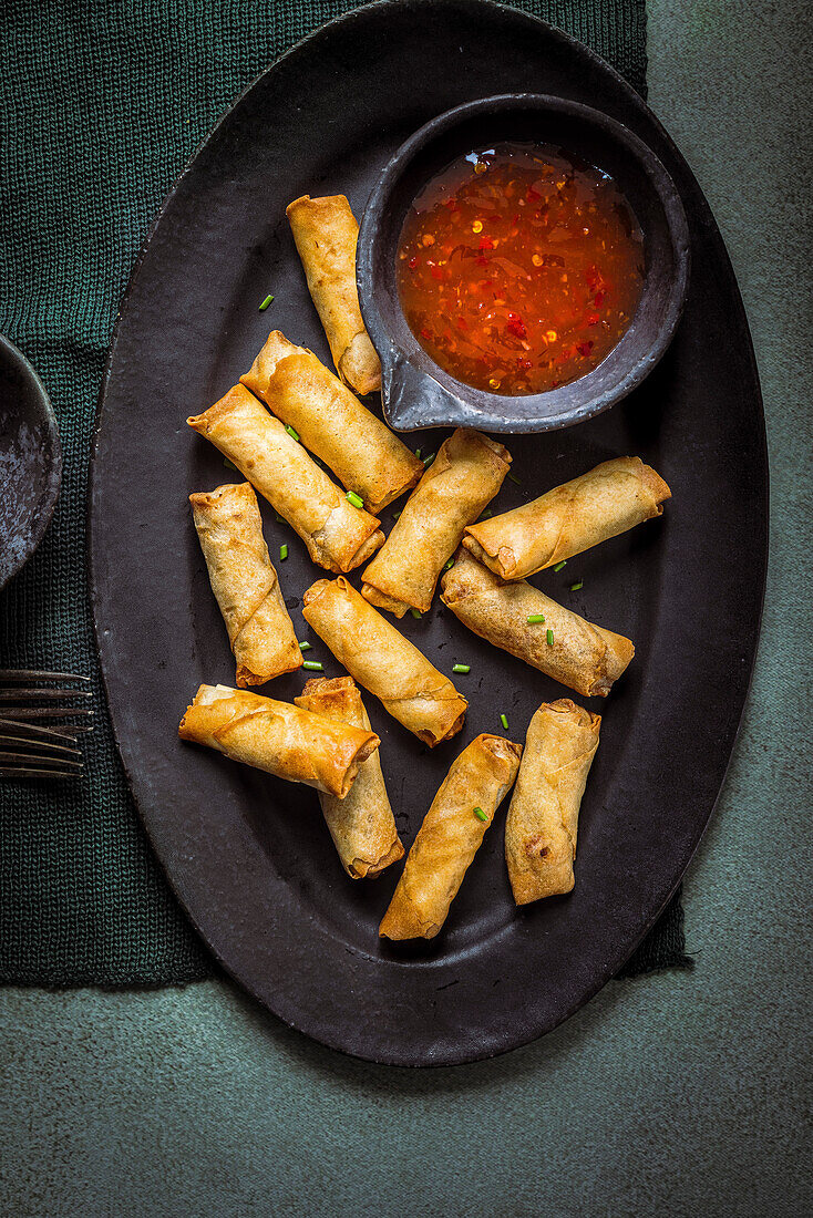 spring rolls served with a spicy dip