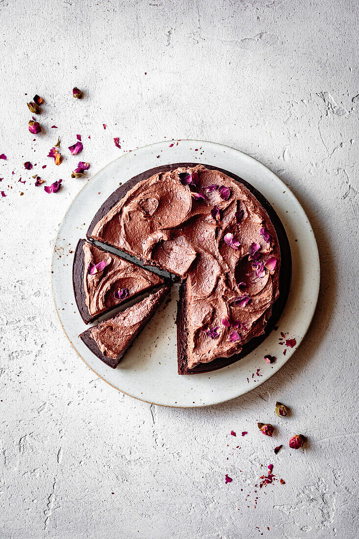 Chocolate cake with chocolate frosting and dried rose petals