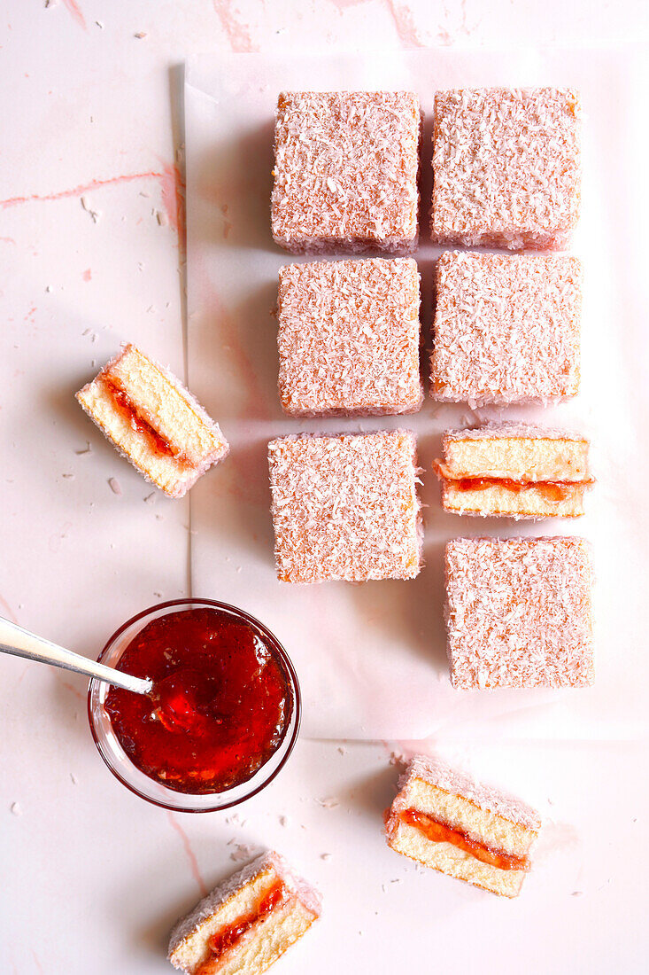 Australian Pink Lamington Small Square Cakes Sandwiched with Strawberry Jam and Coated in Coconut.